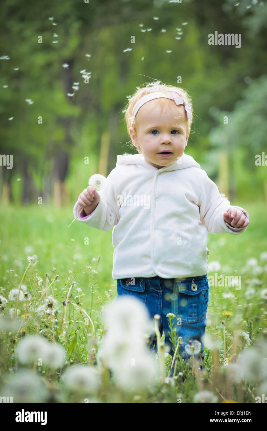 Outdoor portrait of a cute little baby in the grass Stock Photo - Alamy