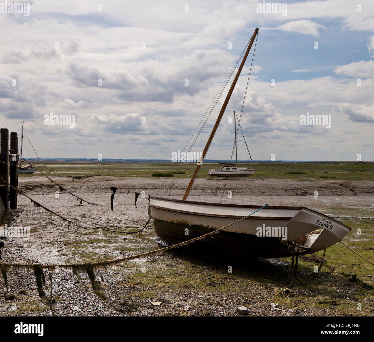 A boat moored on the mud at low tide in Leigh-On Sea Essex England ...