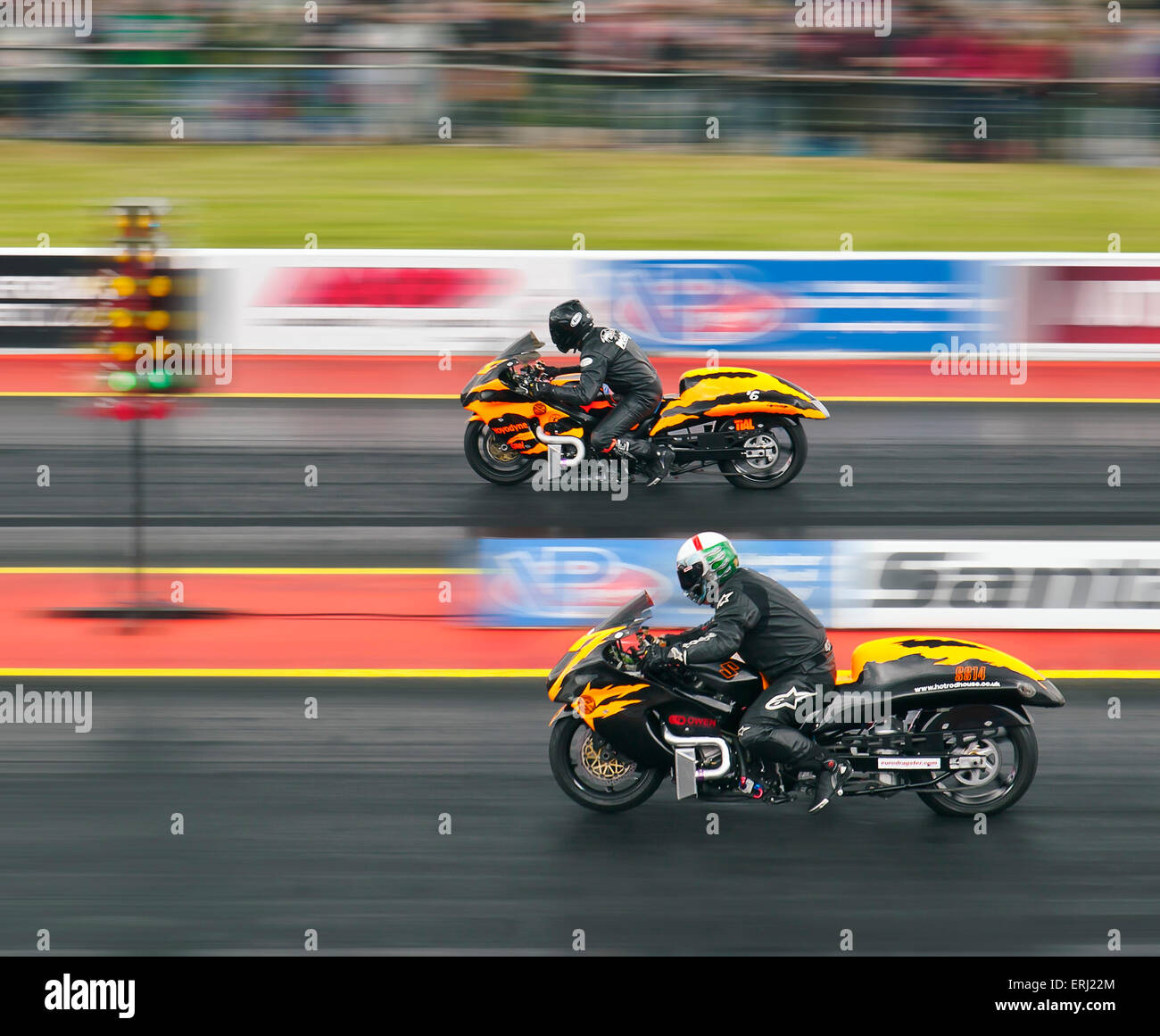 Two Suzuki Hayabusa motorcycles drag racing at Santa Pod raceway. Riders Danny Cockerill nearside Dave Holland far side. Stock Photo
