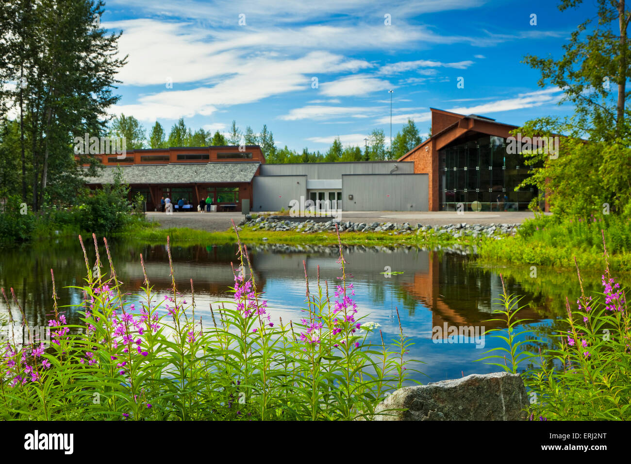 Alaskan Native Heritage Center building reflects on Lake Tiulana, Anchorage, Southcentral Alaska, Summer.None Stock Photo