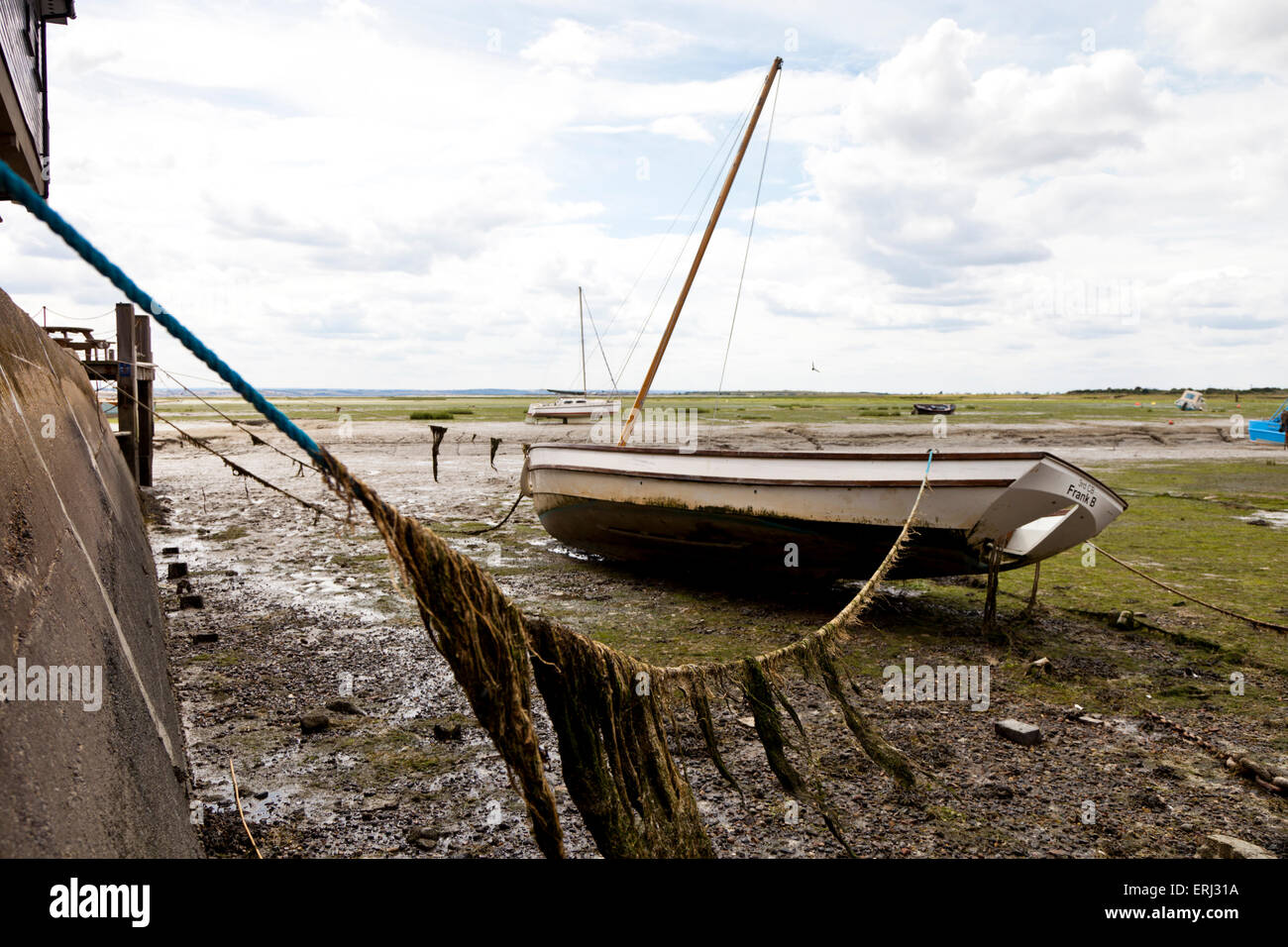 A boat moored on the mud at low tide in Leigh-On Sea Essex England ...