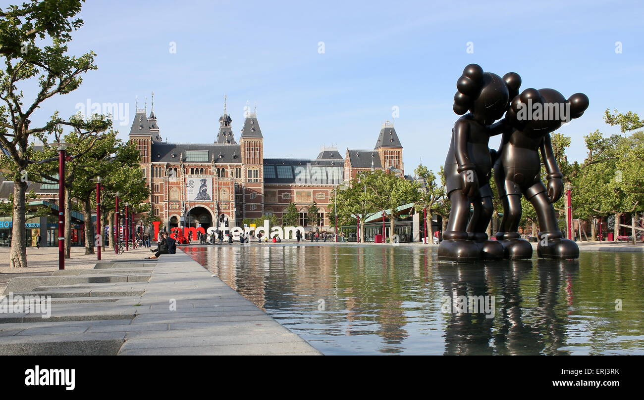 Sculptures by New York artist KAWS during the ArtZuid exhibition on Museumplein square,  Amsterdam. Rijksmuseum in background Stock Photo