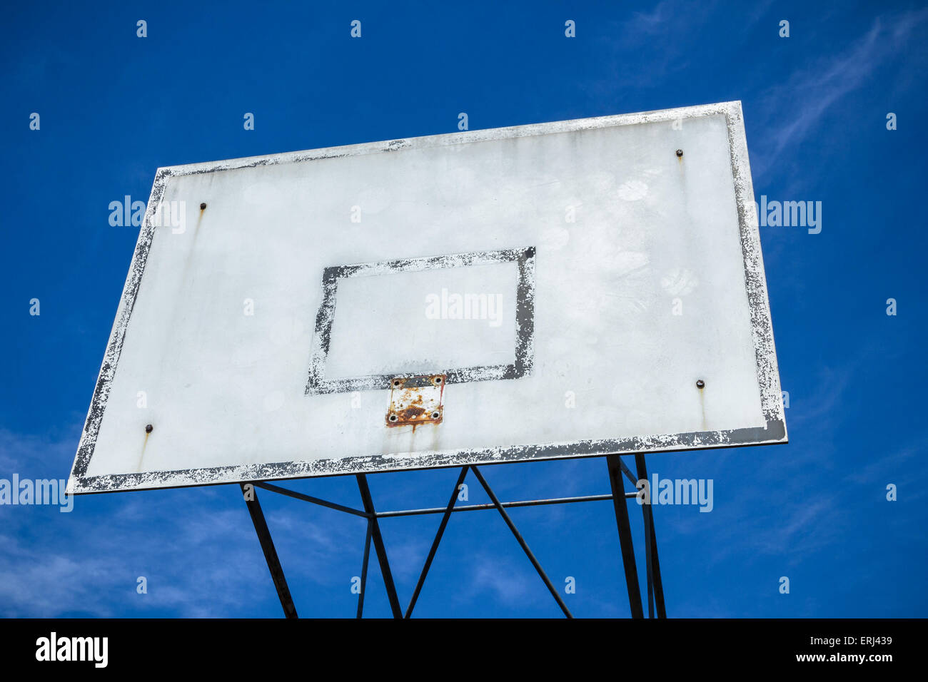 An old basketball hoop consumed by games and matches. Stock Photo