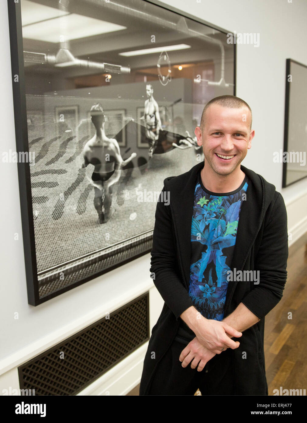 Berlin, Germany. 3rd June, 2015. Photographer Szymon Brodziak stands next to one of his photographic work during a press conference on the photo exhibition 'Newton. Horvat. Brodziak' at the Museum of Photography in Berlin, Germany, 3 June 2015. The exhibition showcases the photographic works of Helmut Newton, Frank Horvat and Szymon Brodziak und runs until 15 November 2015. Photo: JOERG CARSTENSEN/dpa/Alamy Live News Stock Photo