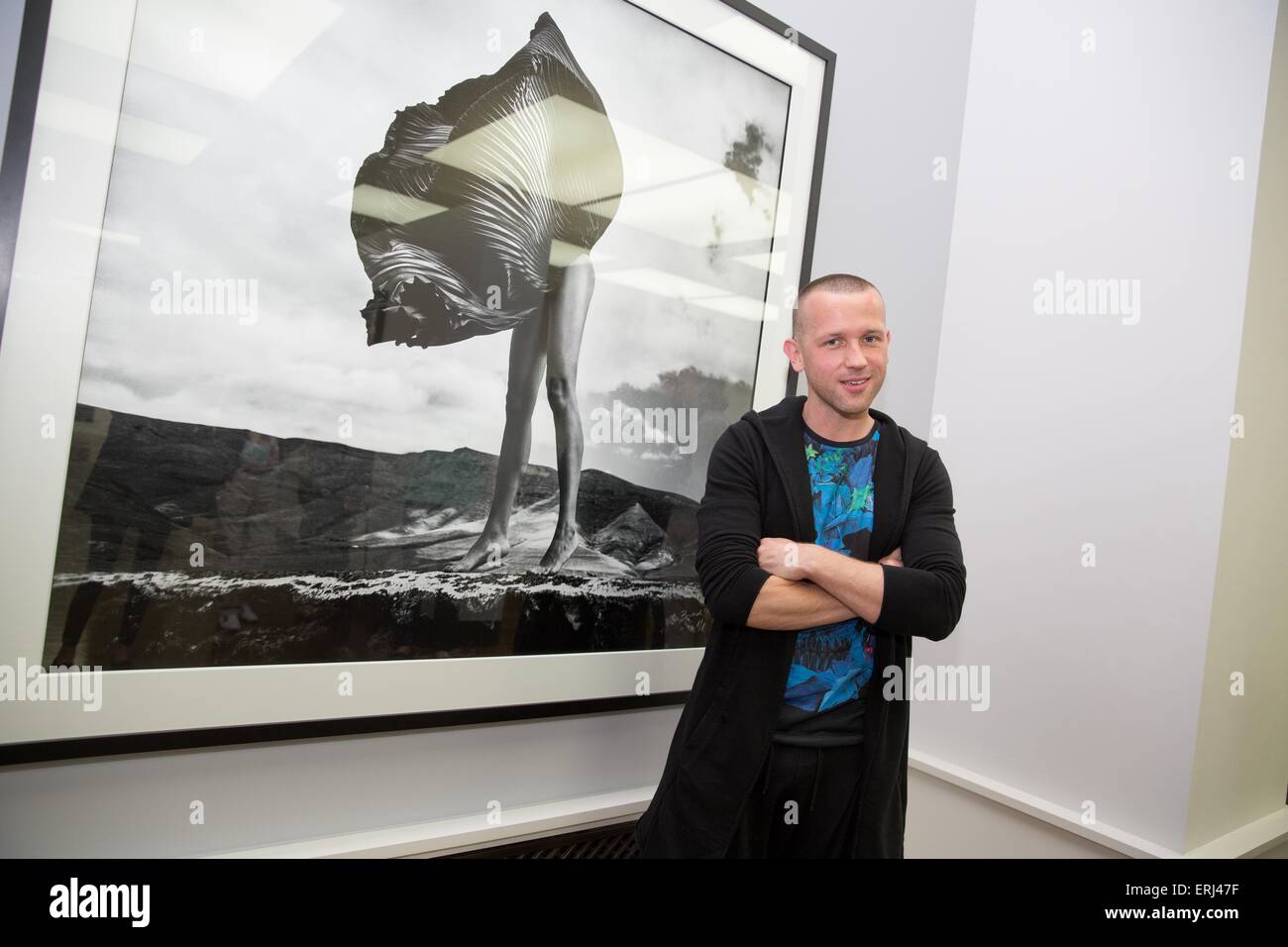 Berlin, Germany. 3rd June, 2015. Photographer Szymon Brodziak stands next to one of his photographic work during a press conference on the photo exhibition 'Newton. Horvat. Brodziak' at the Museum of Photography in Berlin, Germany, 3 June 2015. The exhibition showcases the photographic works of Helmut Newton, Frank Horvat and Szymon Brodziak und runs until 15 November 2015. Photo: JOERG CARSTENSEN/dpa/Alamy Live News Stock Photo