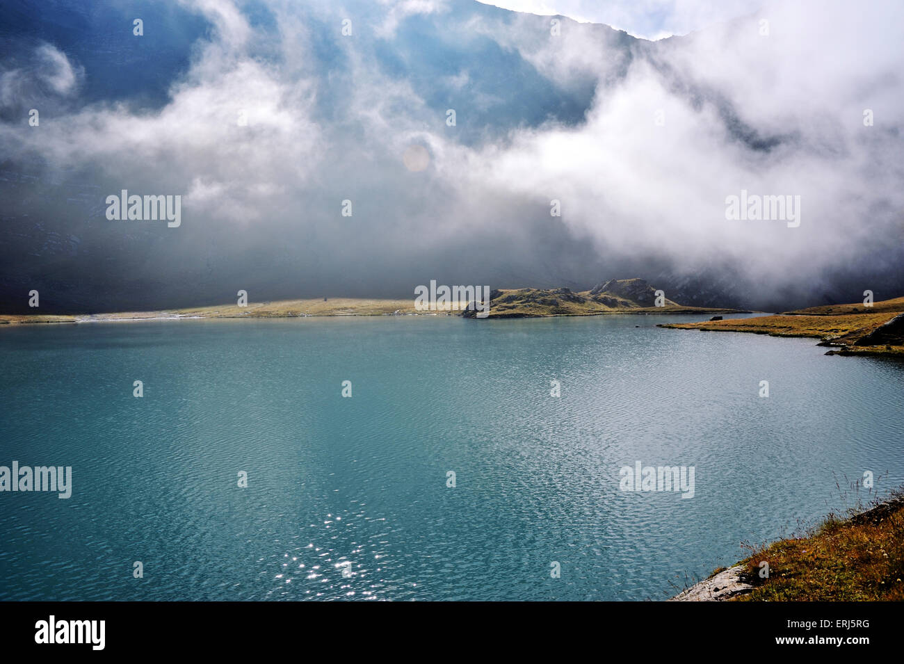 Last Wafts of Mist at the mountain lake Lac Goléon, French Alps, France Stock Photo