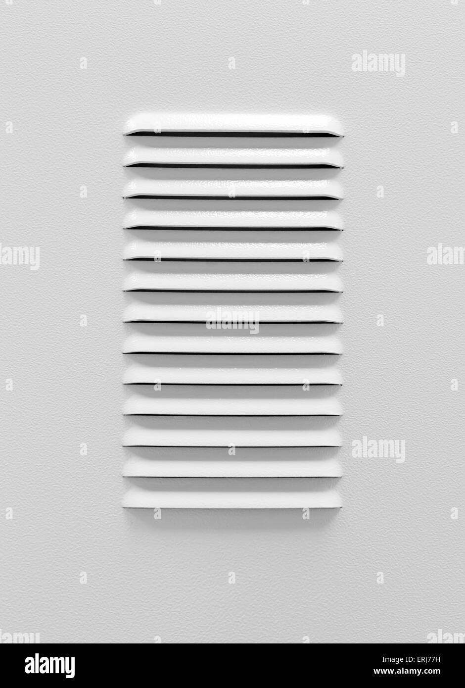 White metal industrial panel with ventilation grille, closeup photo, front view with shadow Stock Photo