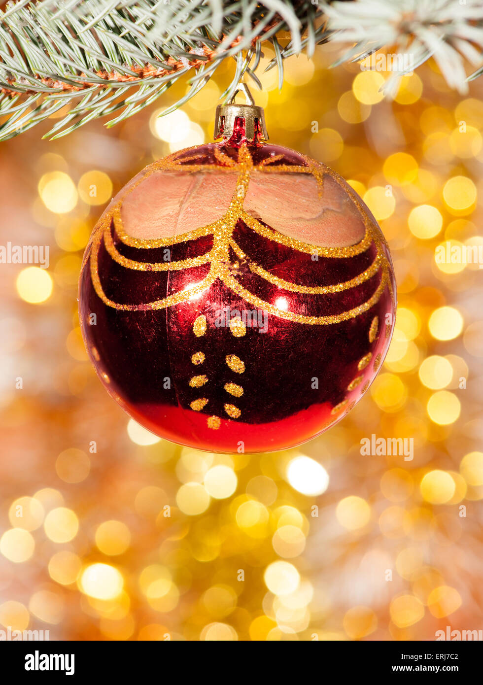 christmas ball on fir tree branch and golden background Stock Photo - Alamy