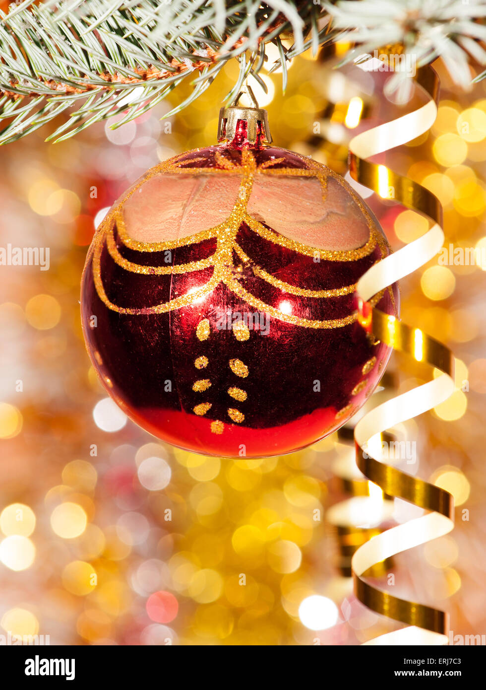 christmas ball on fir tree branch and golden background Stock Photo - Alamy