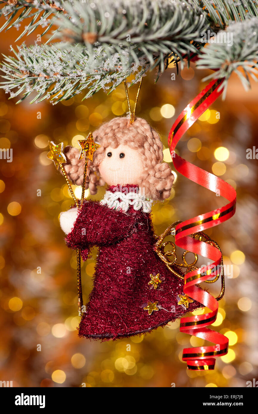 christmas angel on fir tree branch and golden background Stock Photo Alamy