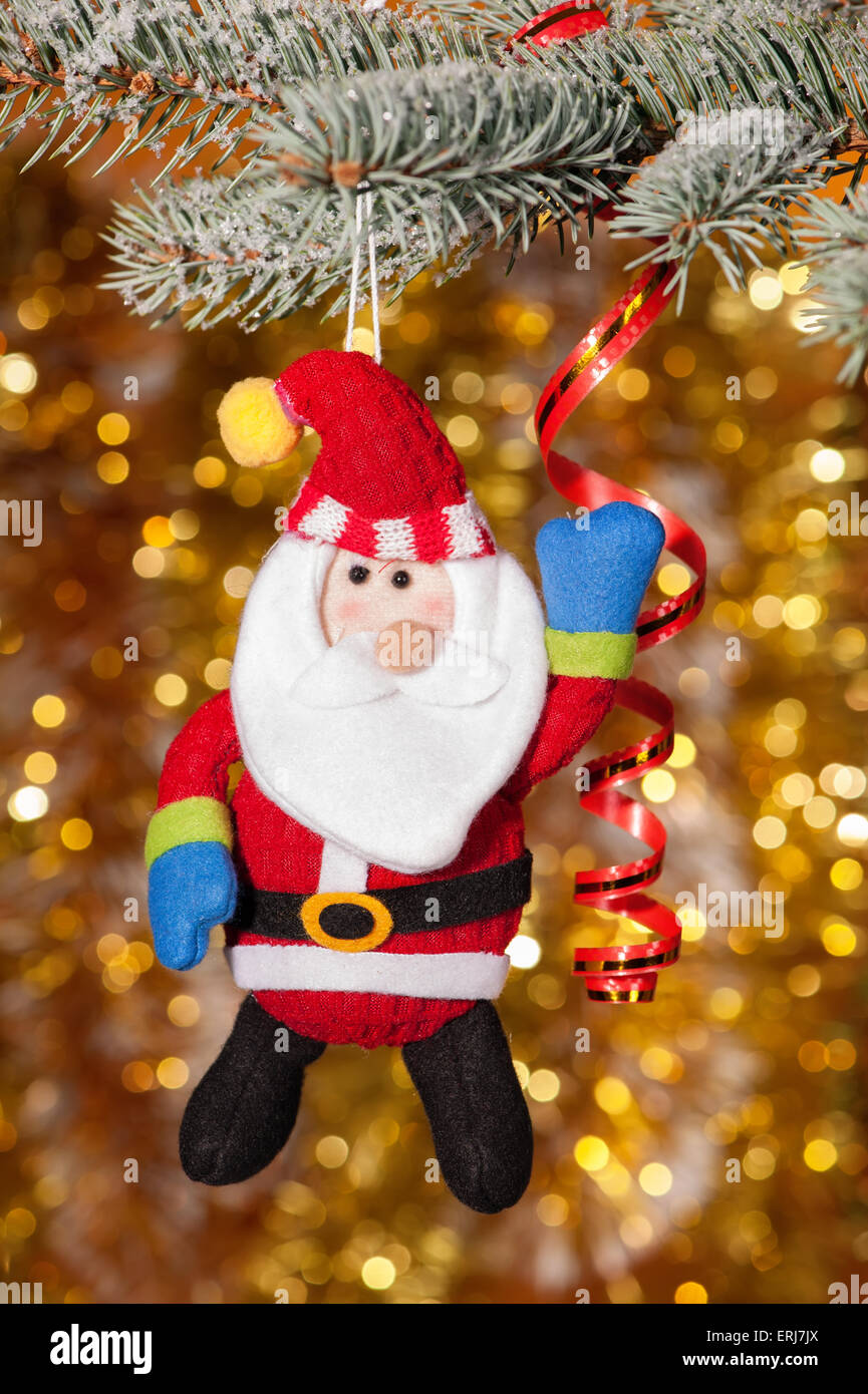 christmas angel on fir tree branch and golden background Stock Photo