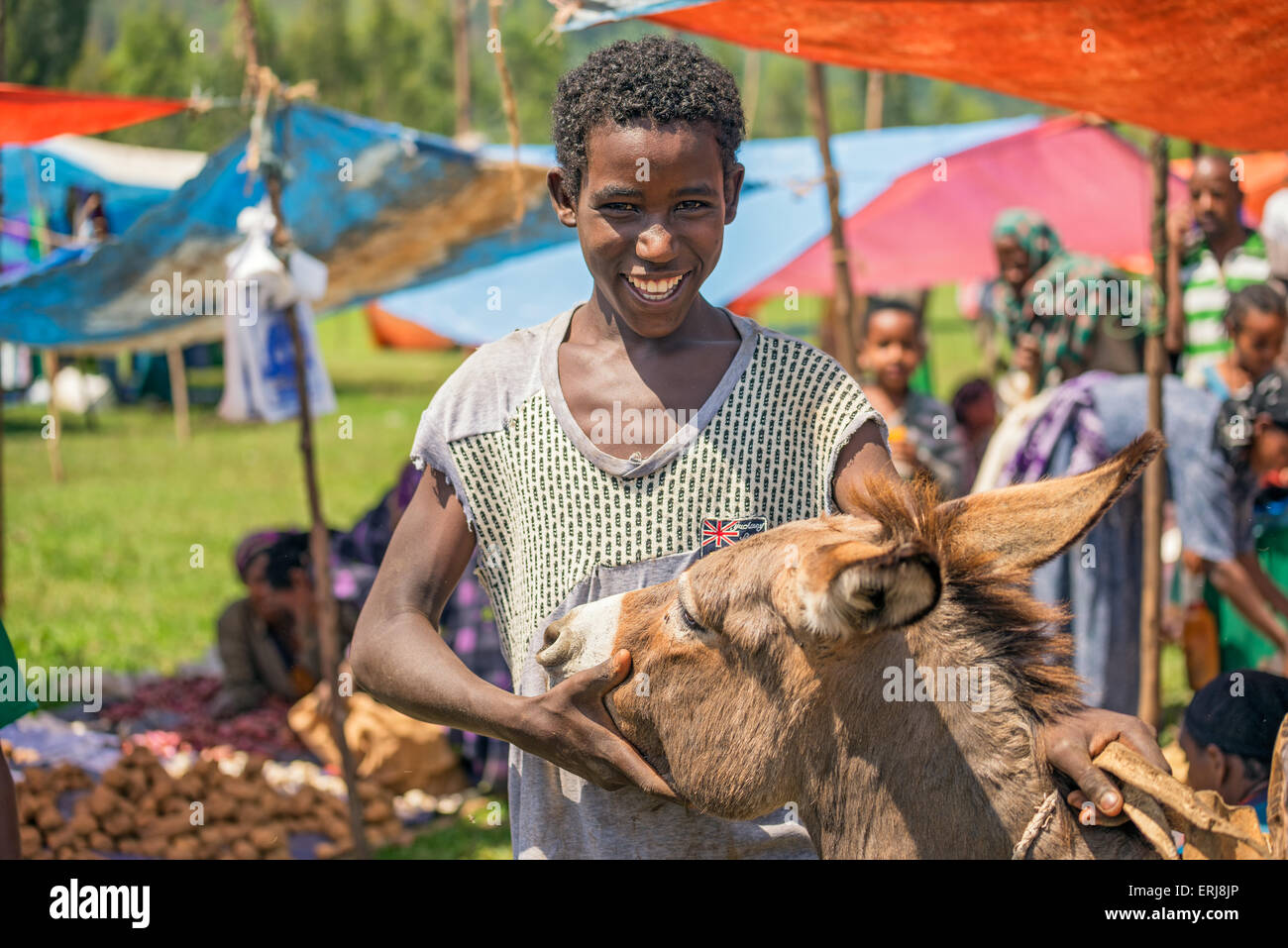 Young ethiopian boy with his donkey at a popular local market  in Jimma. Stock Photo