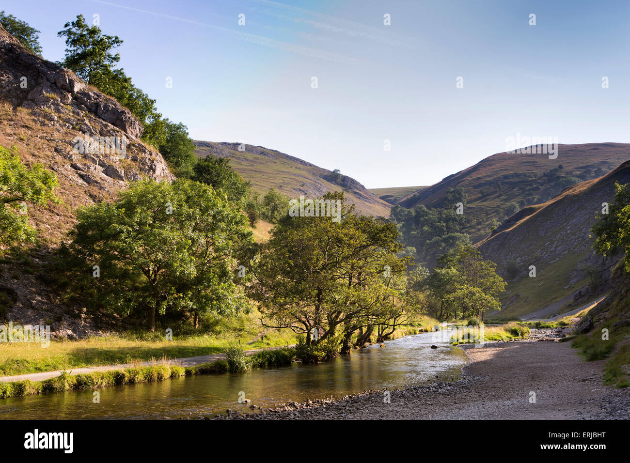 UK, England, Derbyshire, Dovedale, riverbank shingle footpath beside River Dove in summer Stock Photo