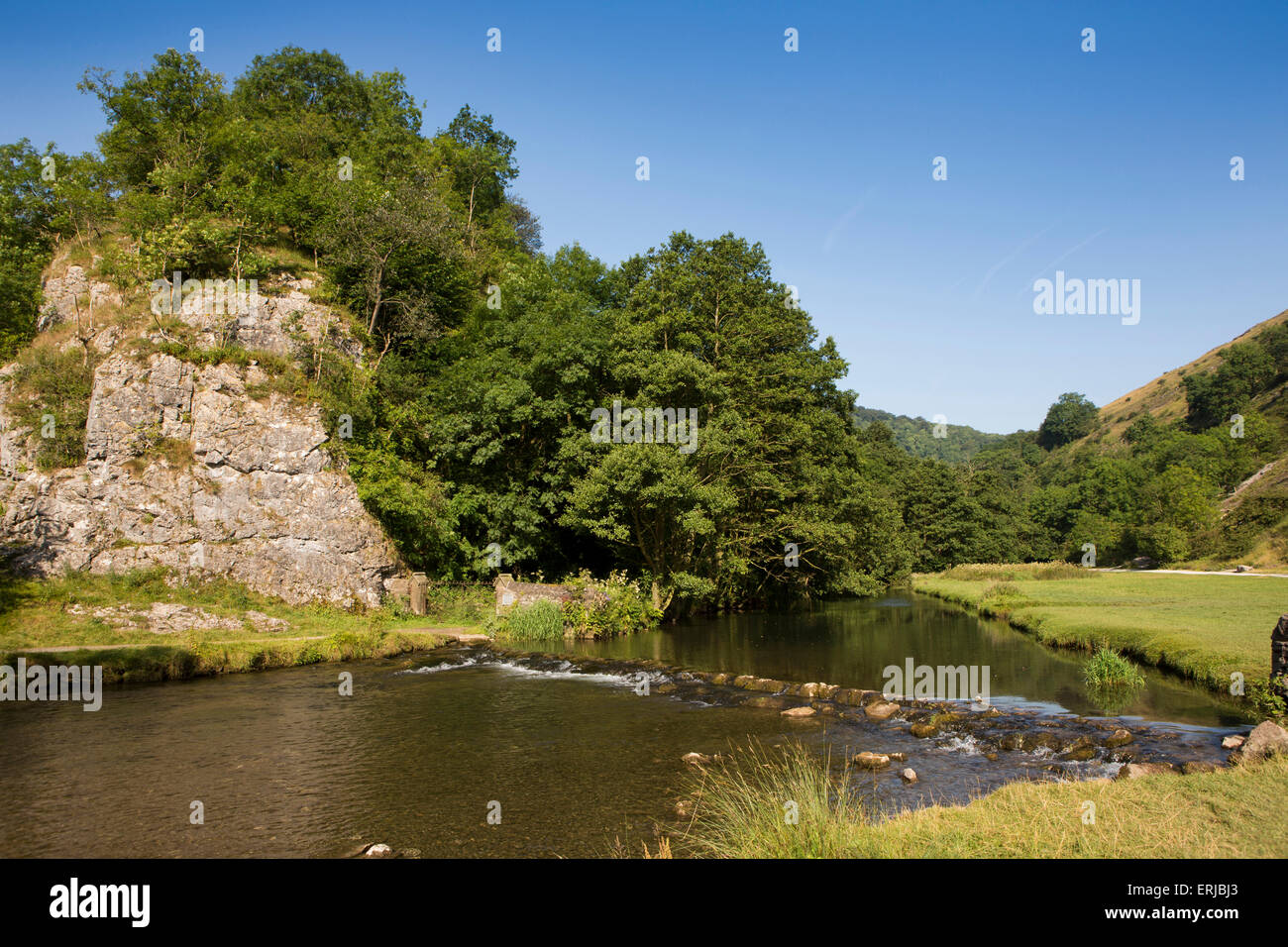 UK, England, Derbyshire, Dovedale, River Dove flowing over weir in summer Stock Photo