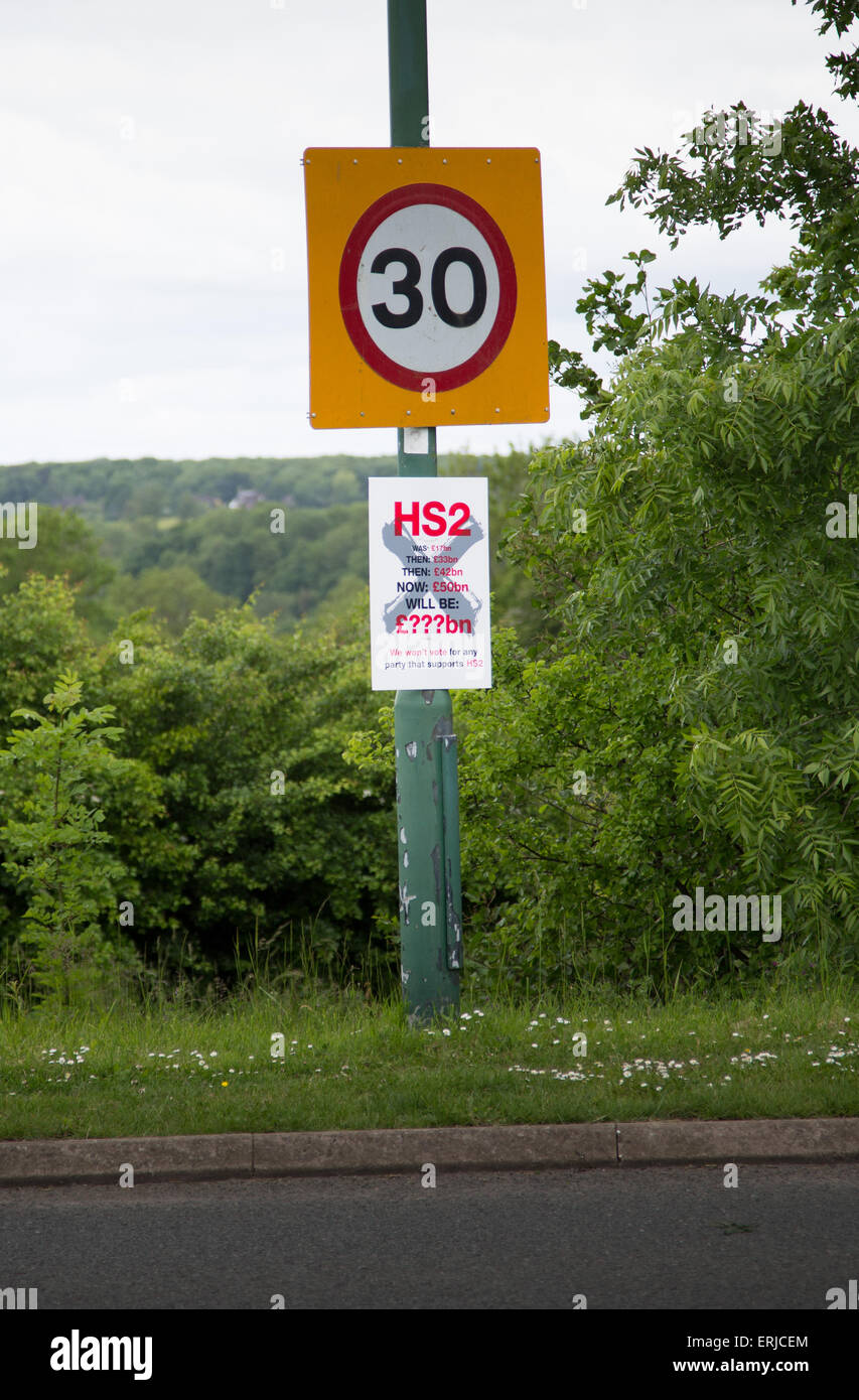 UK 30 mph roadsign with a Stop HS2 notice on it Stock Photo