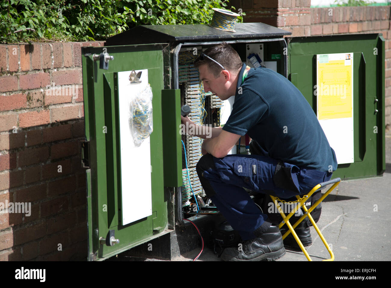 BT engineer on a junction box on the roadside England UK Stock Photo
