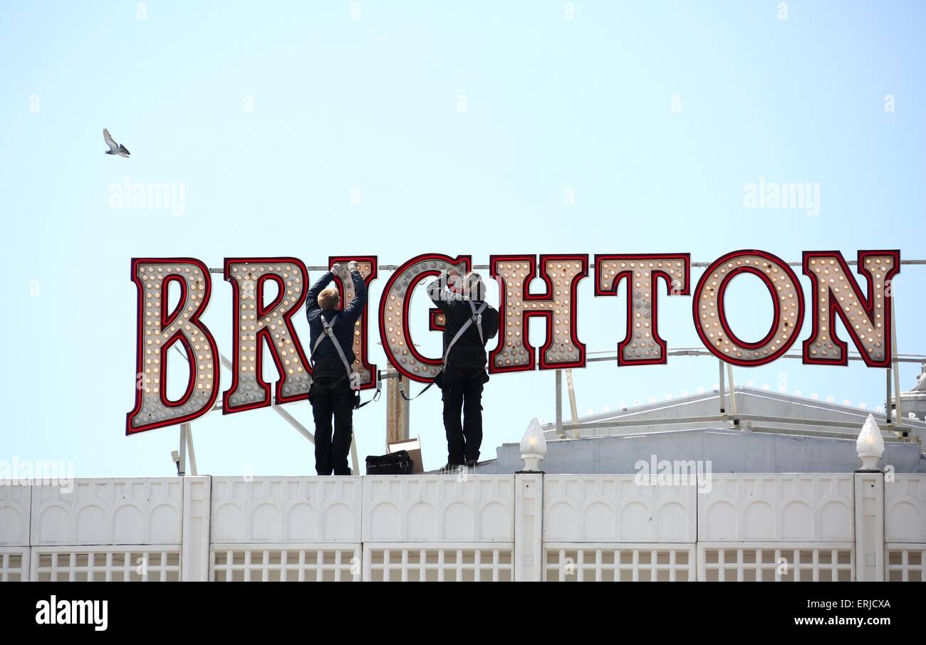 Maintenance men replace some of the 62,000 light bulbs it takes to illuminate Brighton Pier. Mandatory byline James Boardman Stock Photo