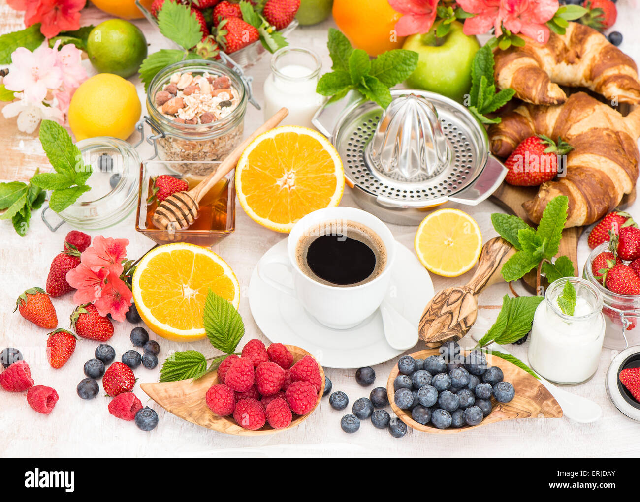 Breakfast table setting with coffee, croissants, cereal granola ... Breakfast table setting with coffee, croissants, cereal granola ...
