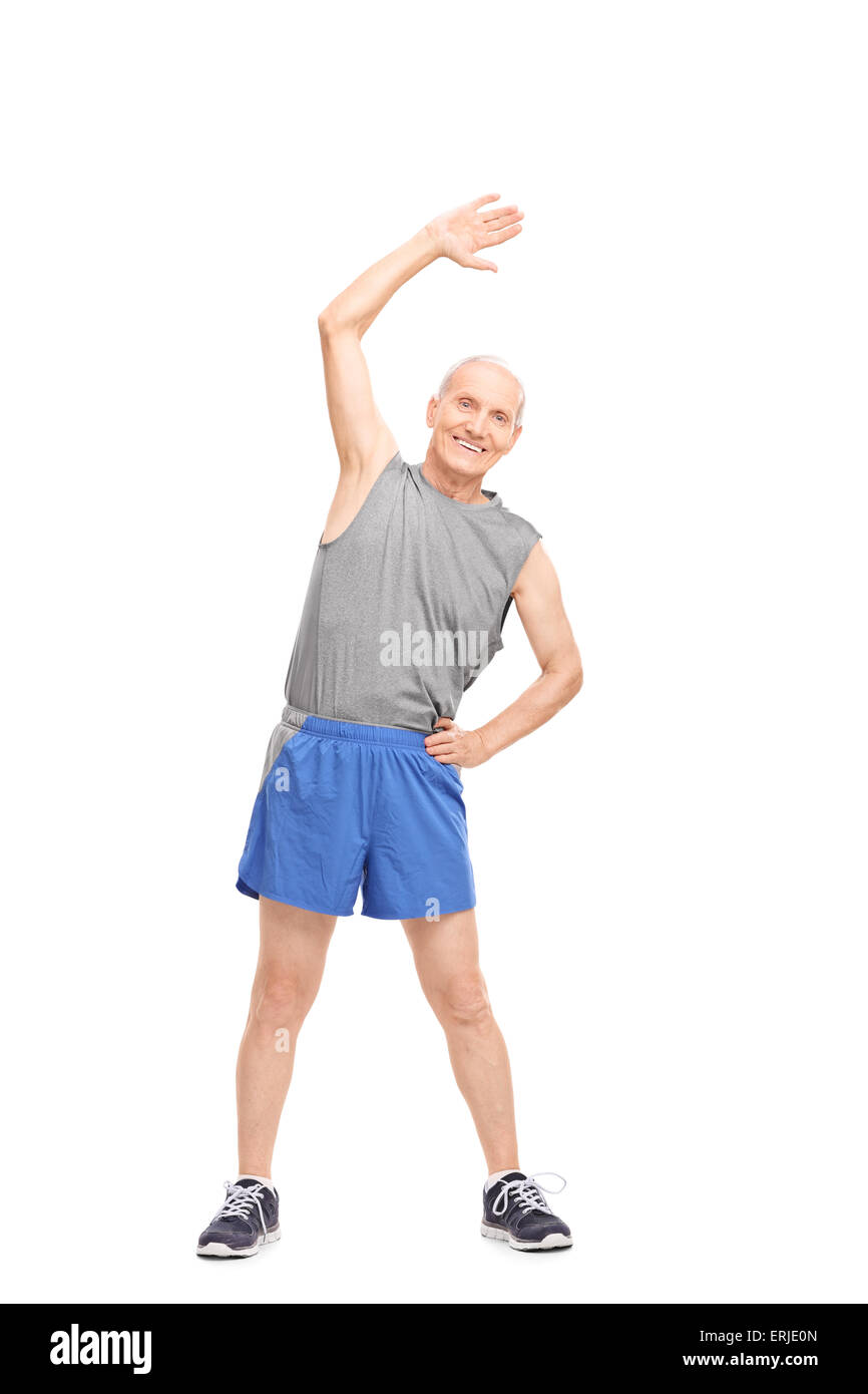 Full length portrait of an active senior doing stretching exercises and looking at the camera isolated on white background Stock Photo