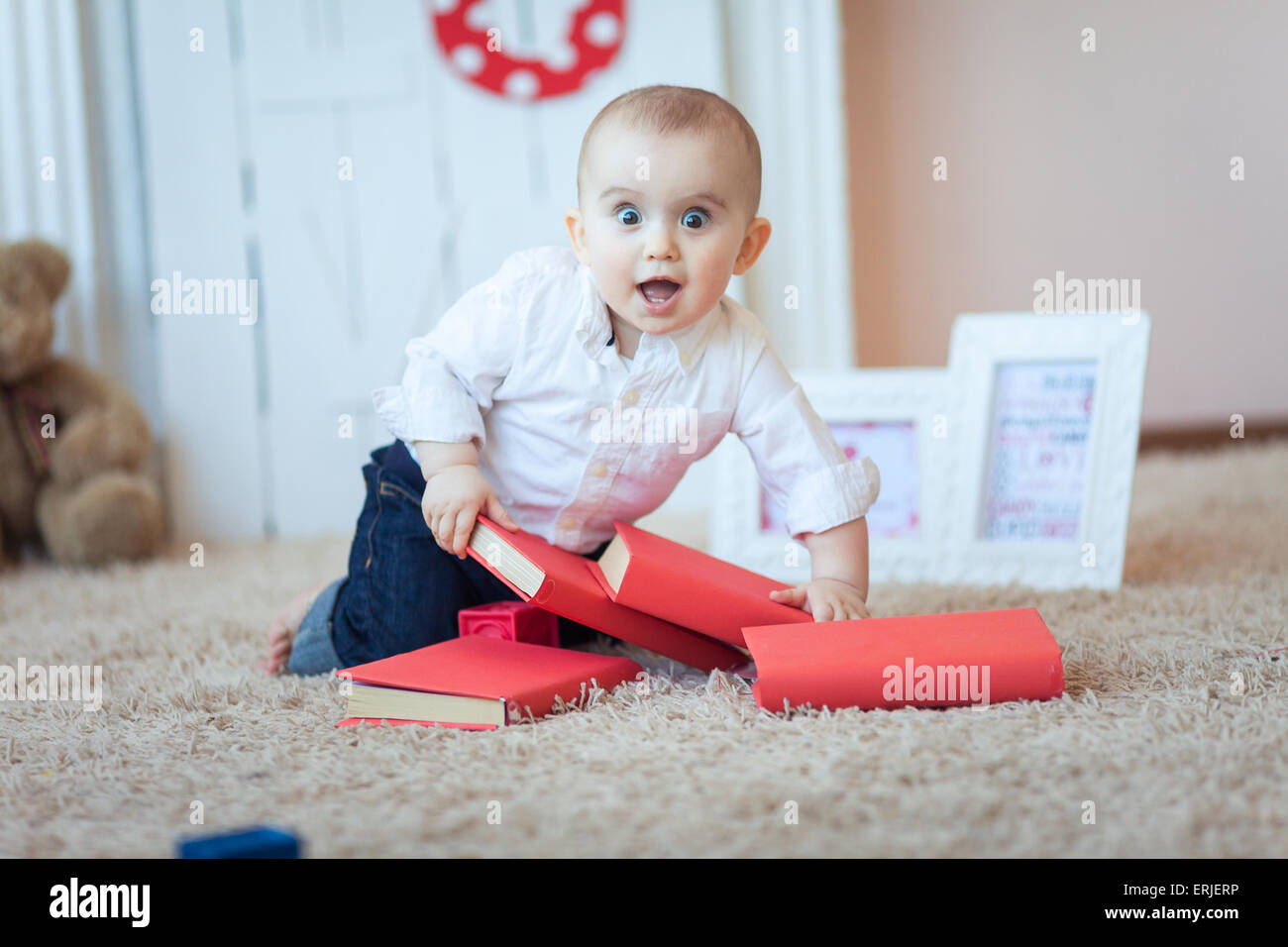 Funny baby with books Stock Photo - Alamy