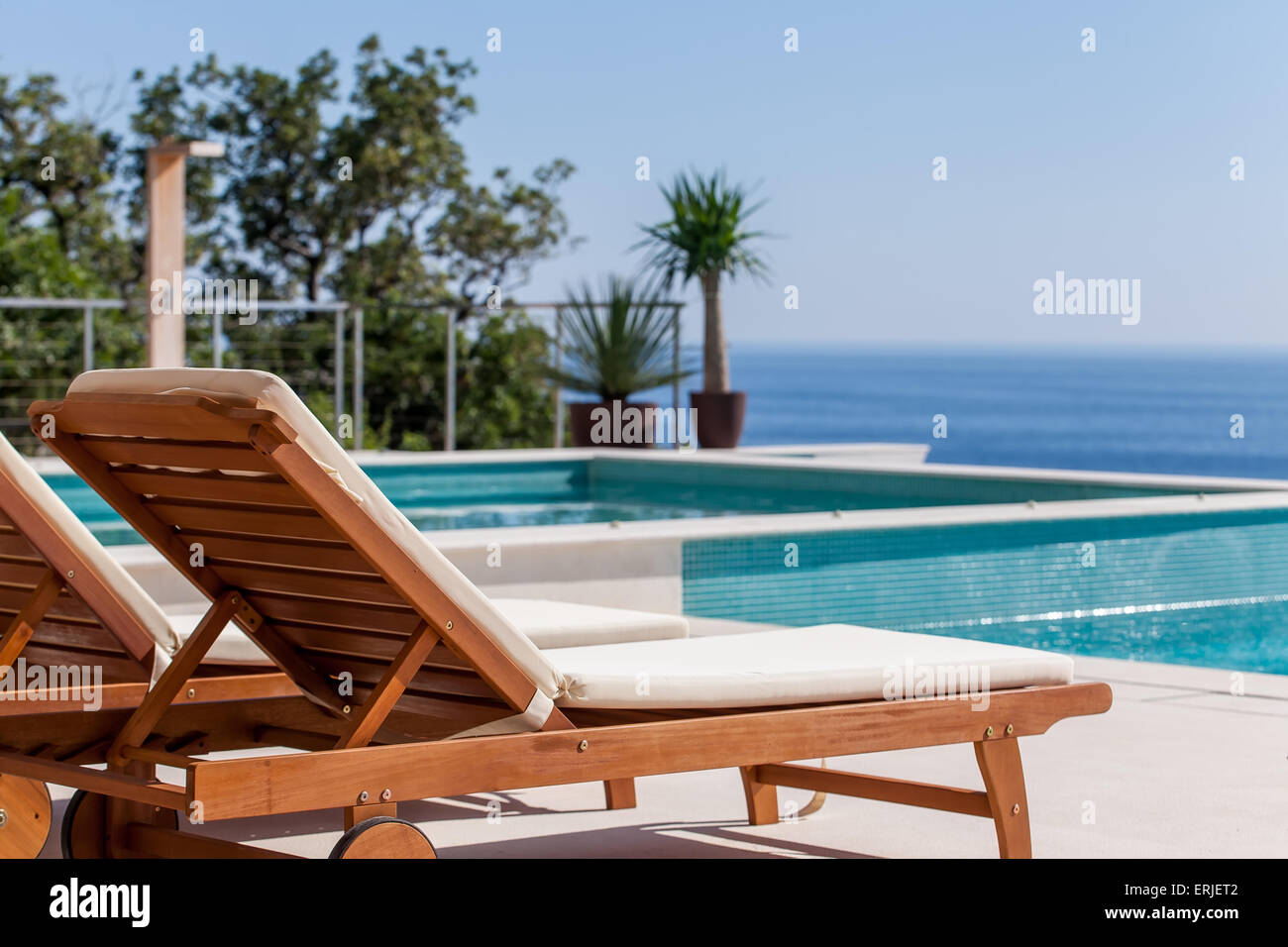 Luxury swimming pool and deck chair Stock Photo Alamy