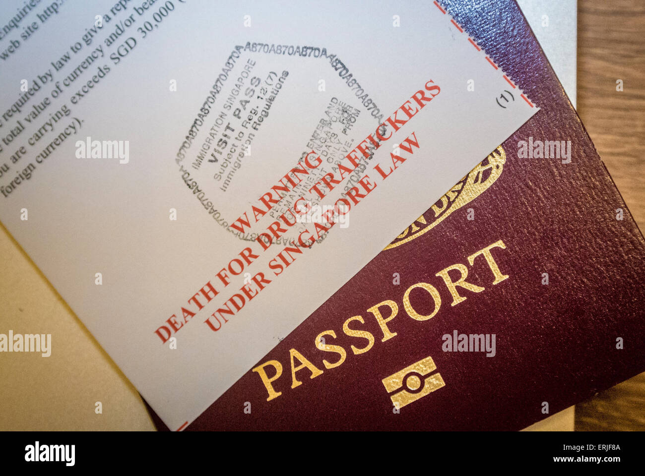 Warning to drug traffickers sign on immigration documents with European passport - Singapore Stock Photo