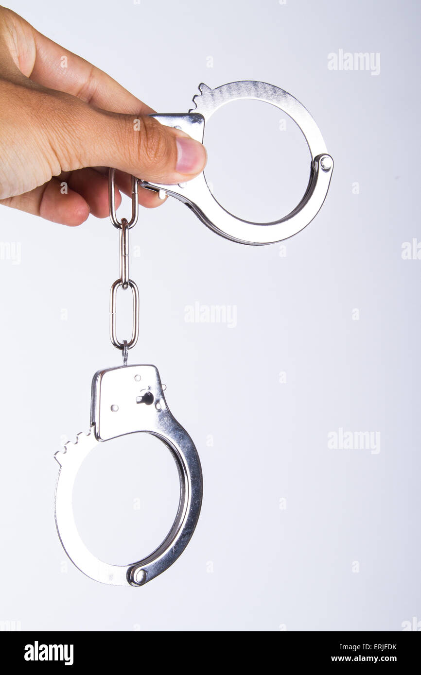 Hand holding handcuffs, isolated on white background Stock Photo Alamy