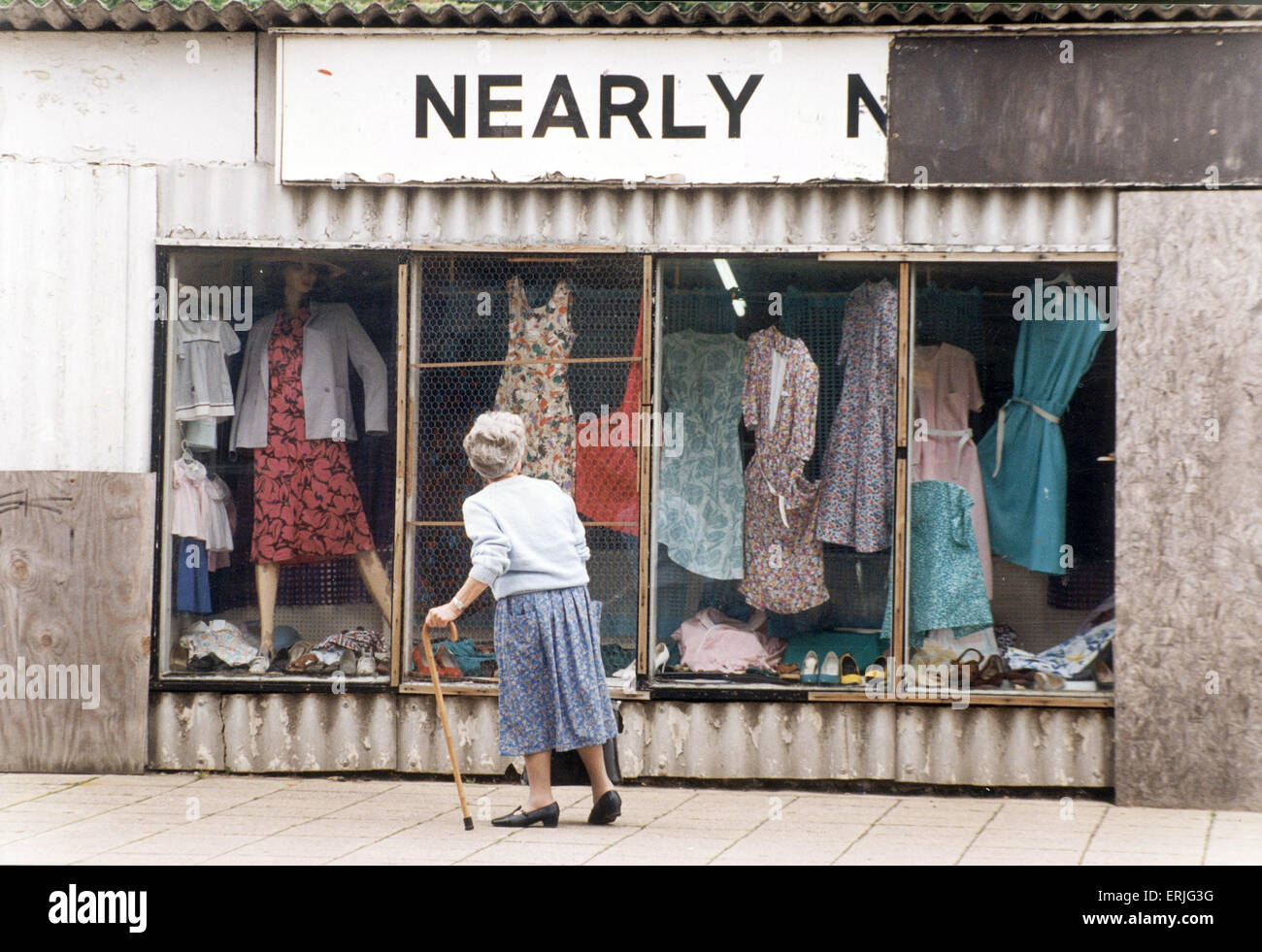 An elderly woman pauses to look at the World War Two prefab shop on the corner of Corporation Street and Hill Street, Coventry possibly for the last time as they are due to be demolished to make way for the re-development . 3rd June 1994 Stock Photo