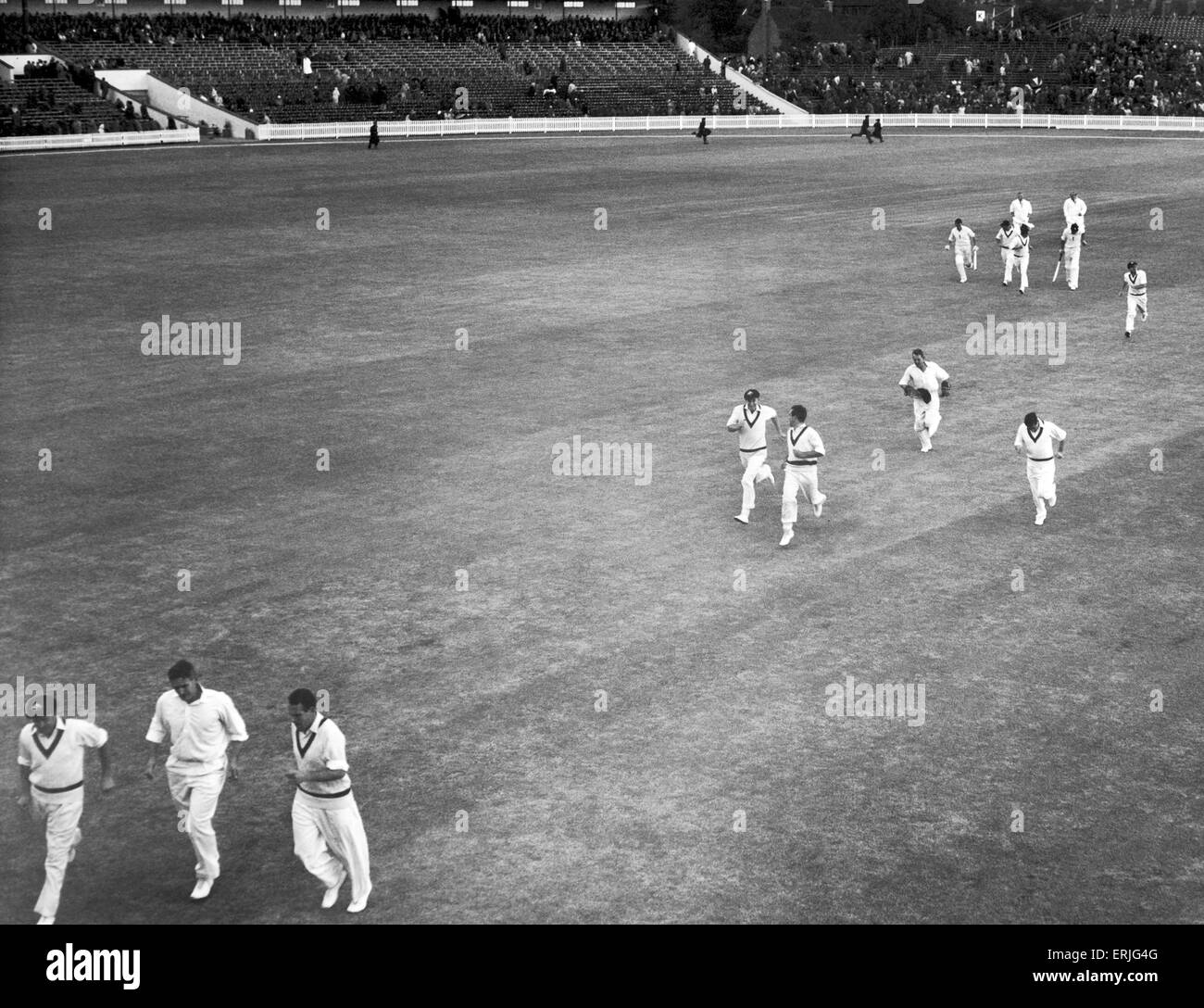 Australian cricket tour of England for the Ashes. England v Australia First Test match at Edgbaston. Cricketers rush off the Edgbaston pitch as plays is stopped early due to rain. 8th June 1961. Stock Photo