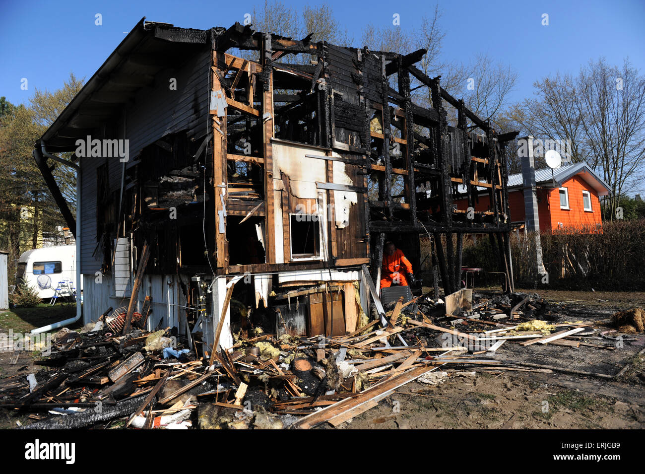 Two Police Men Examine House Destroyed By Fire Stock Photo