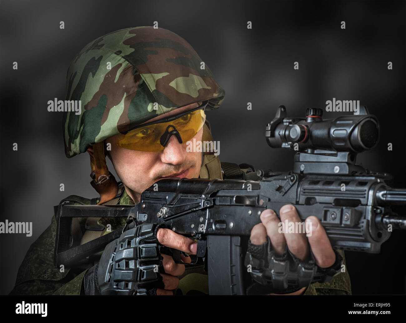 Young handsome soldier (sniper) aiming a machine gun Stock Photo