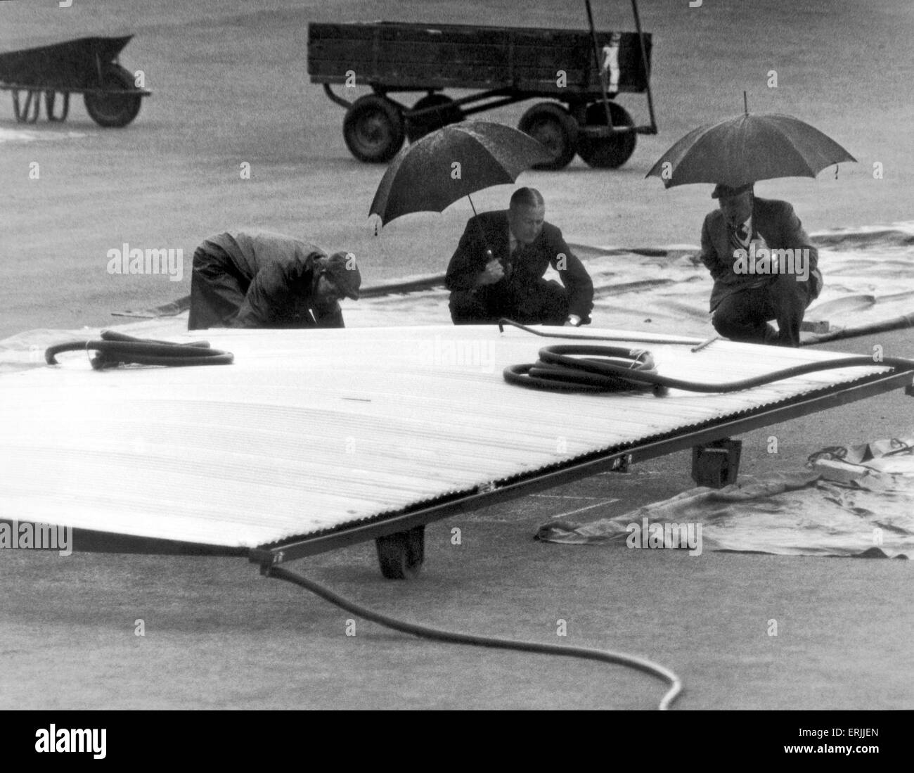 Australian cricket tour of England for the Ashes. England v Australia First Test match at Edgbaston. Umpires Sid Buller and Frank Lee inspecting the wicket with groundsman Bernard Flack before play was abandoned for the day due to rain. 12th June 1961. Stock Photo