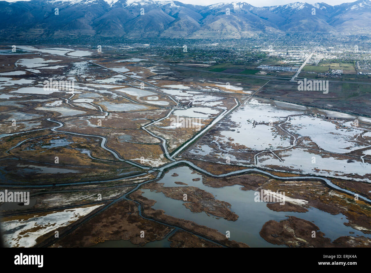 Aerial view of ponds and canal network near Salt Lake City, Utah with mountains in background Stock Photo