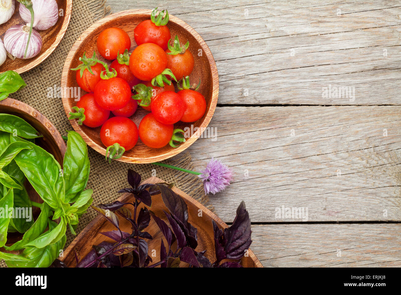 Fresh farmers tomatoes and basil on wood table with copy space Stock ...