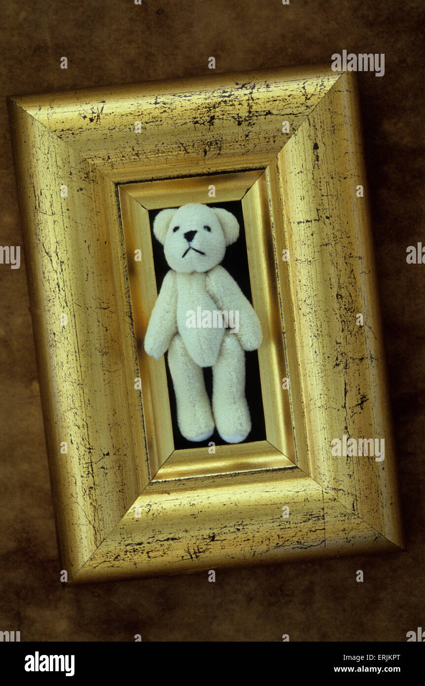 Golden frame containing model of furry white teddy bear walking out of frame Stock Photo