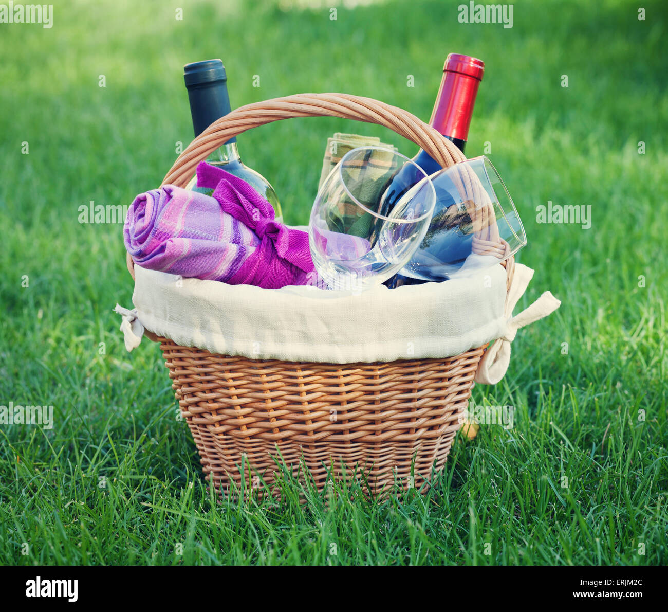 Outdoor picnic basket with wine bottles and glasses on lawn Stock Photo ...