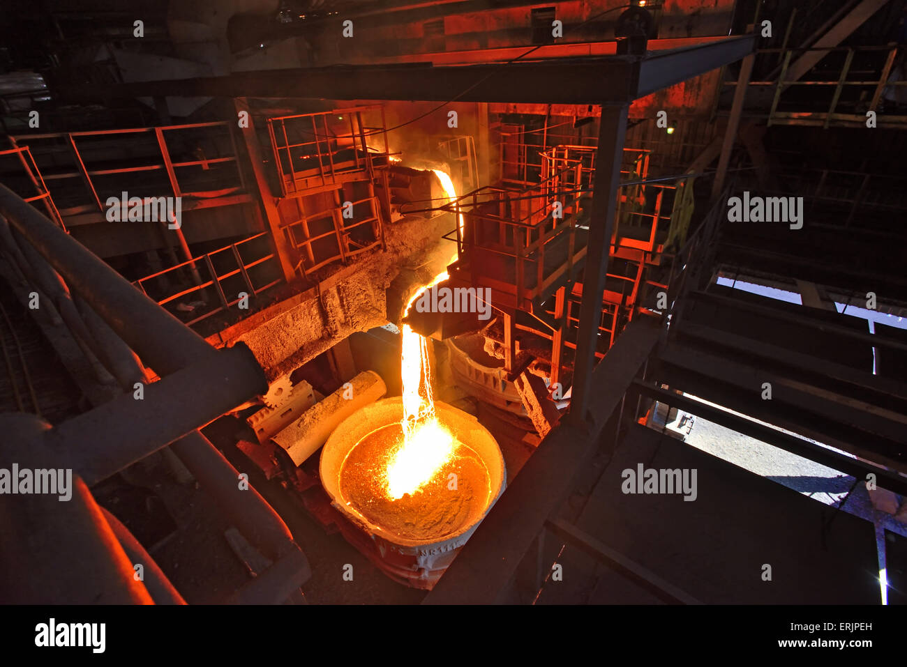 Liquid iron from the ladle inside of steel plant Stock Photo