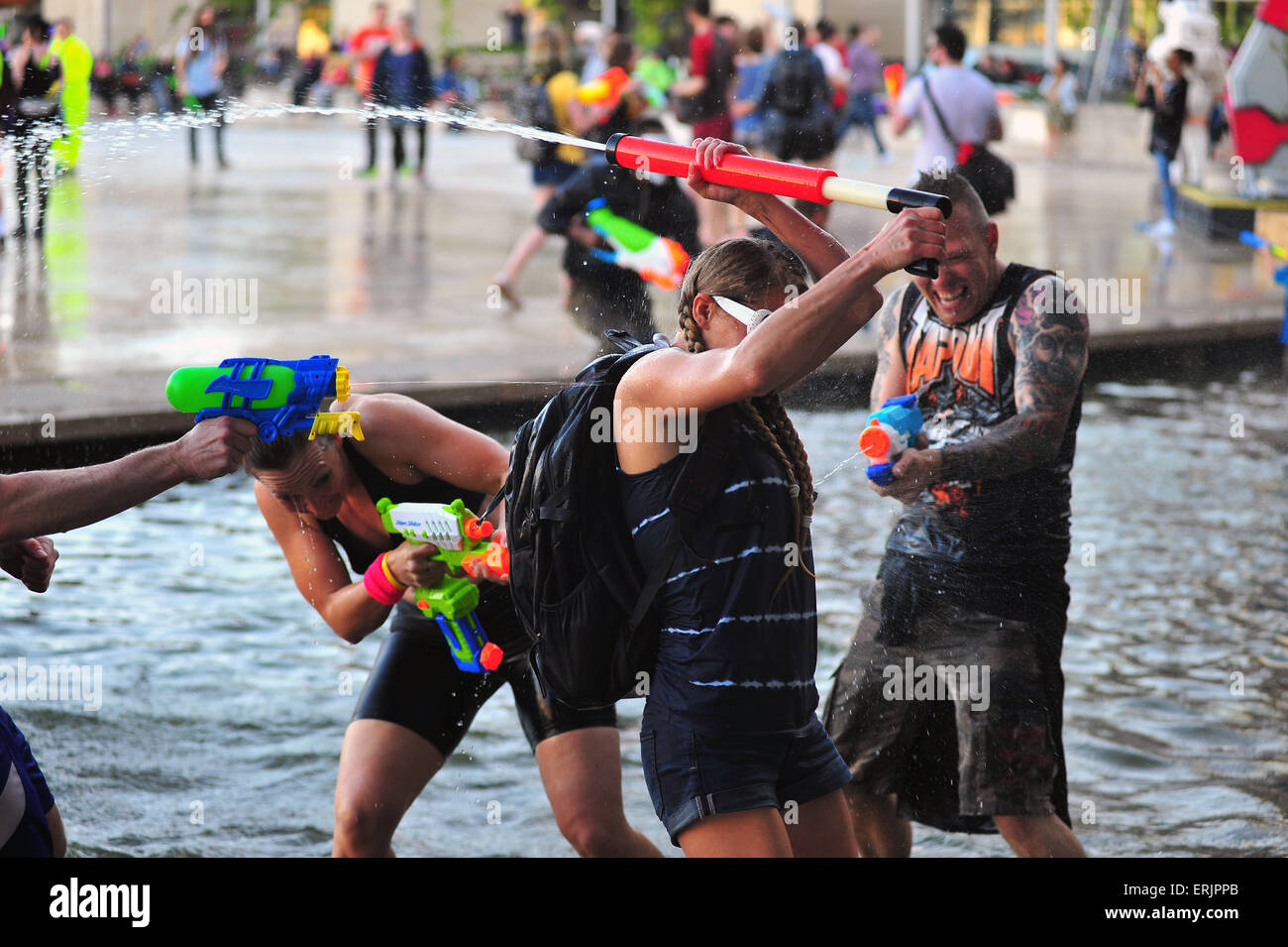 Bristol, UK. 3rd June 2015 In the centre of Bristol as temperatures reach 18 degrees Celsius hundreds gather for a giant water fight. Using water pistols and balloons people cooled themselves off from the evening sun and celebrated the recent warmer weather at an event organized by the Bristol Smile Instigation Collective. Credit:  Jonny White/Alamy Live News Stock Photo