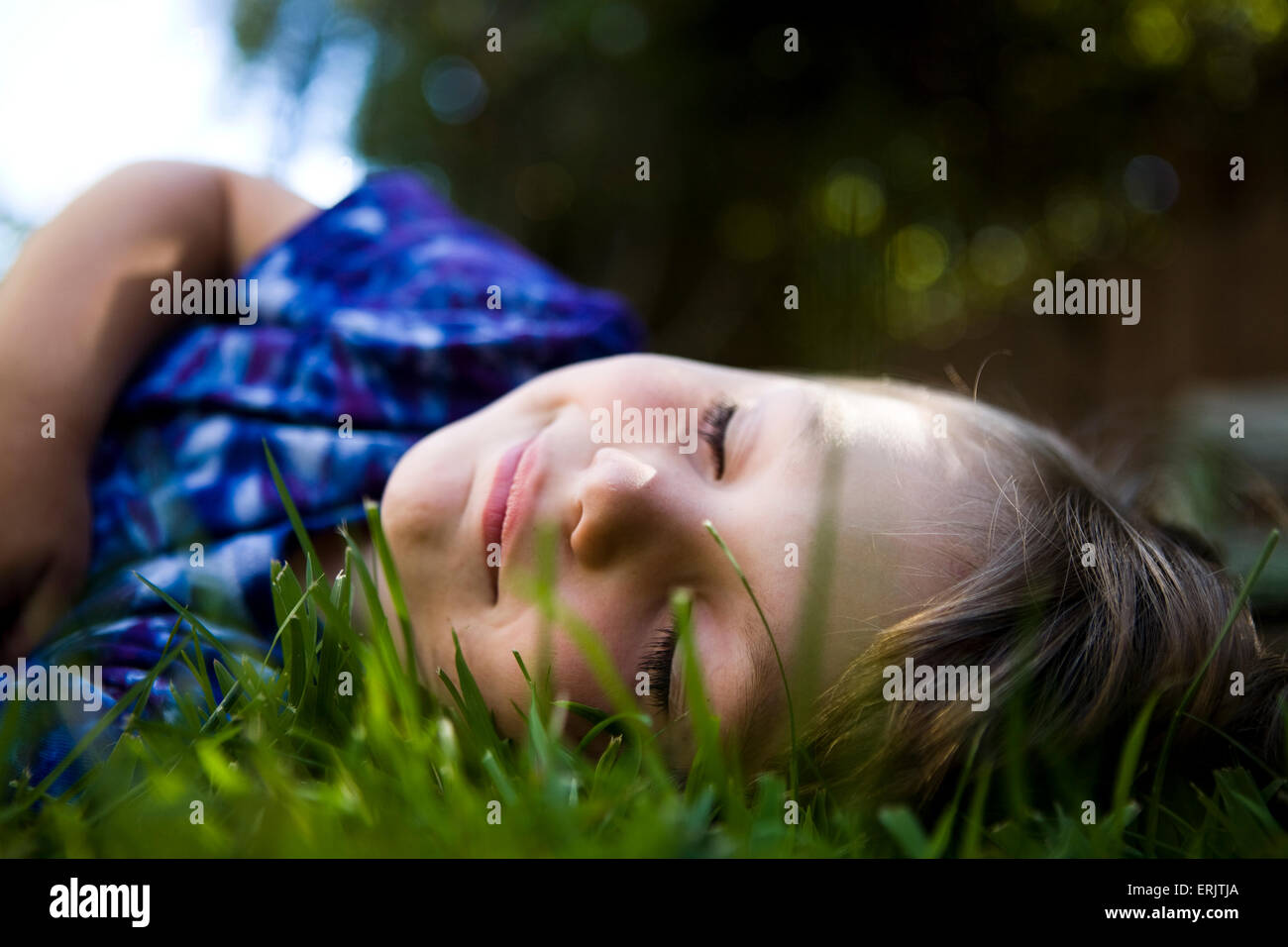 young cute boy sleeping and dreaming in the grass Stock Photo