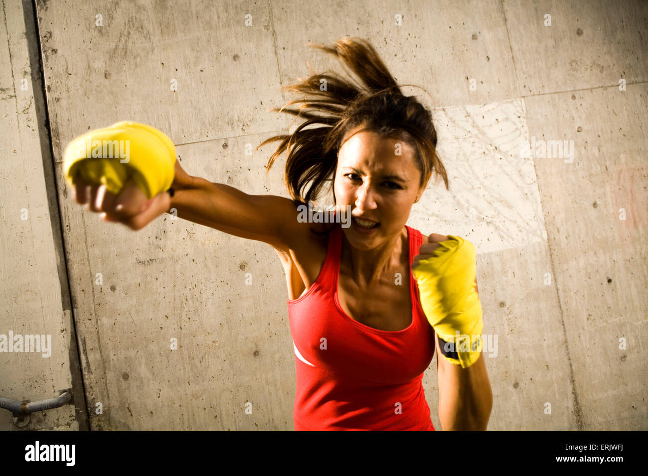 Strong brunette woman boxes in warehouse. Stock Photo