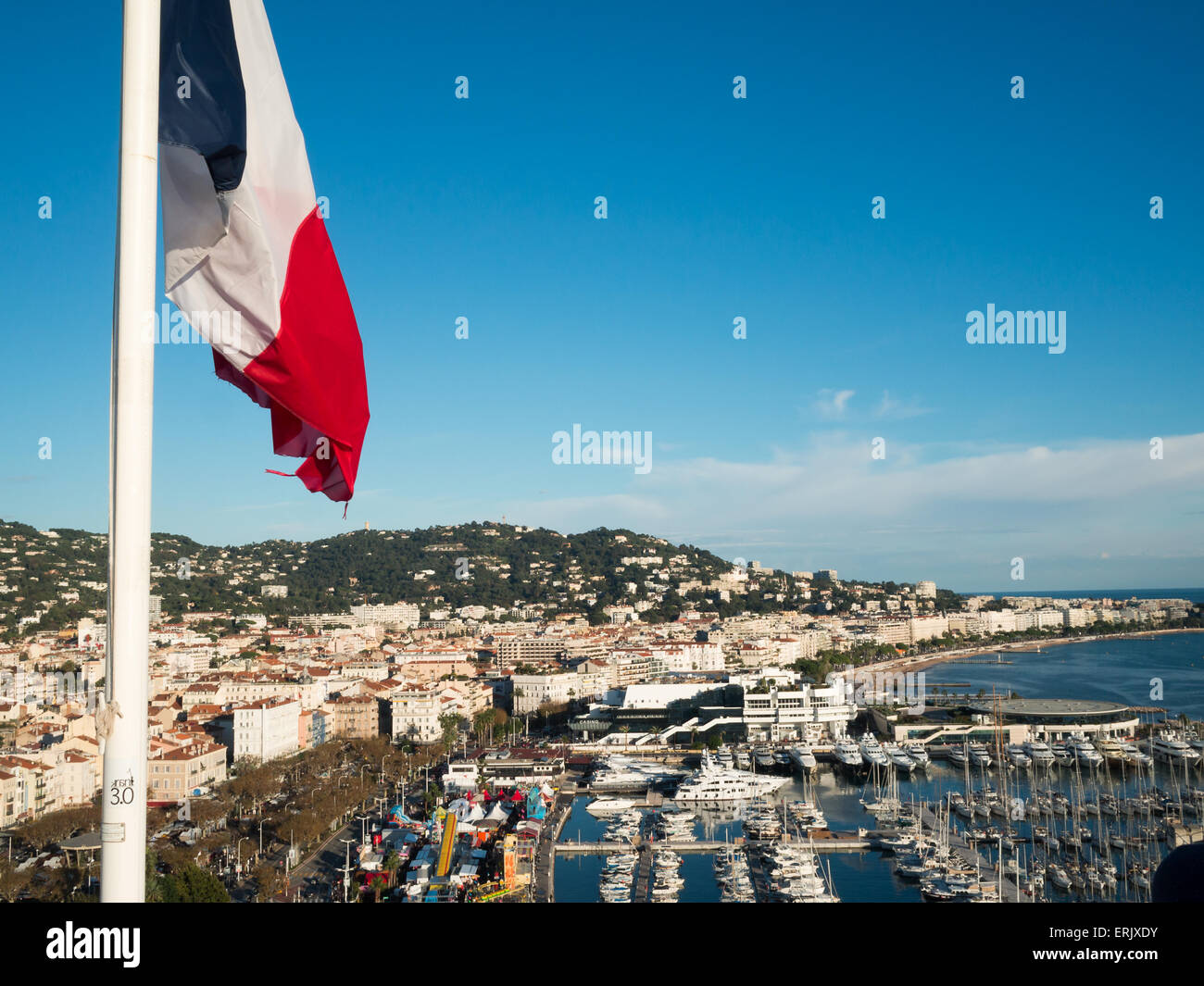 View of Cannes marina from the castle with France flag Stock