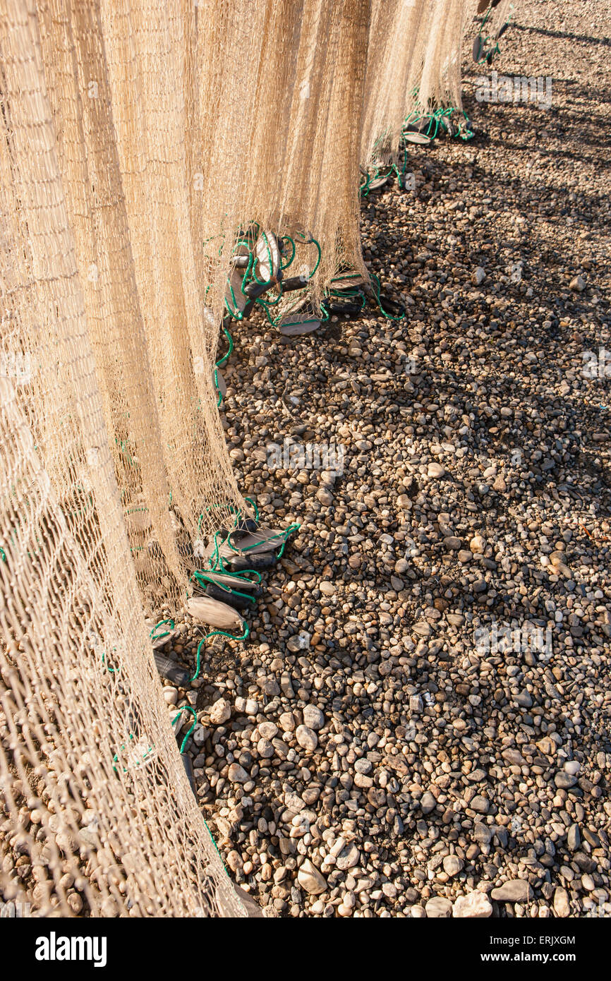 Detail view of a fishing net hanging to dry on the beach of the Kobuk River, Shungnak, Arctic Alaska, summer Stock Photo