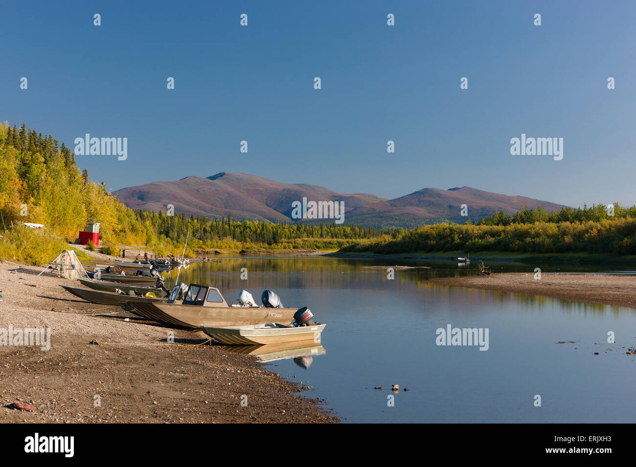 Motor boats moored on a beach along the Kobuk river, Shungnak, Arctic