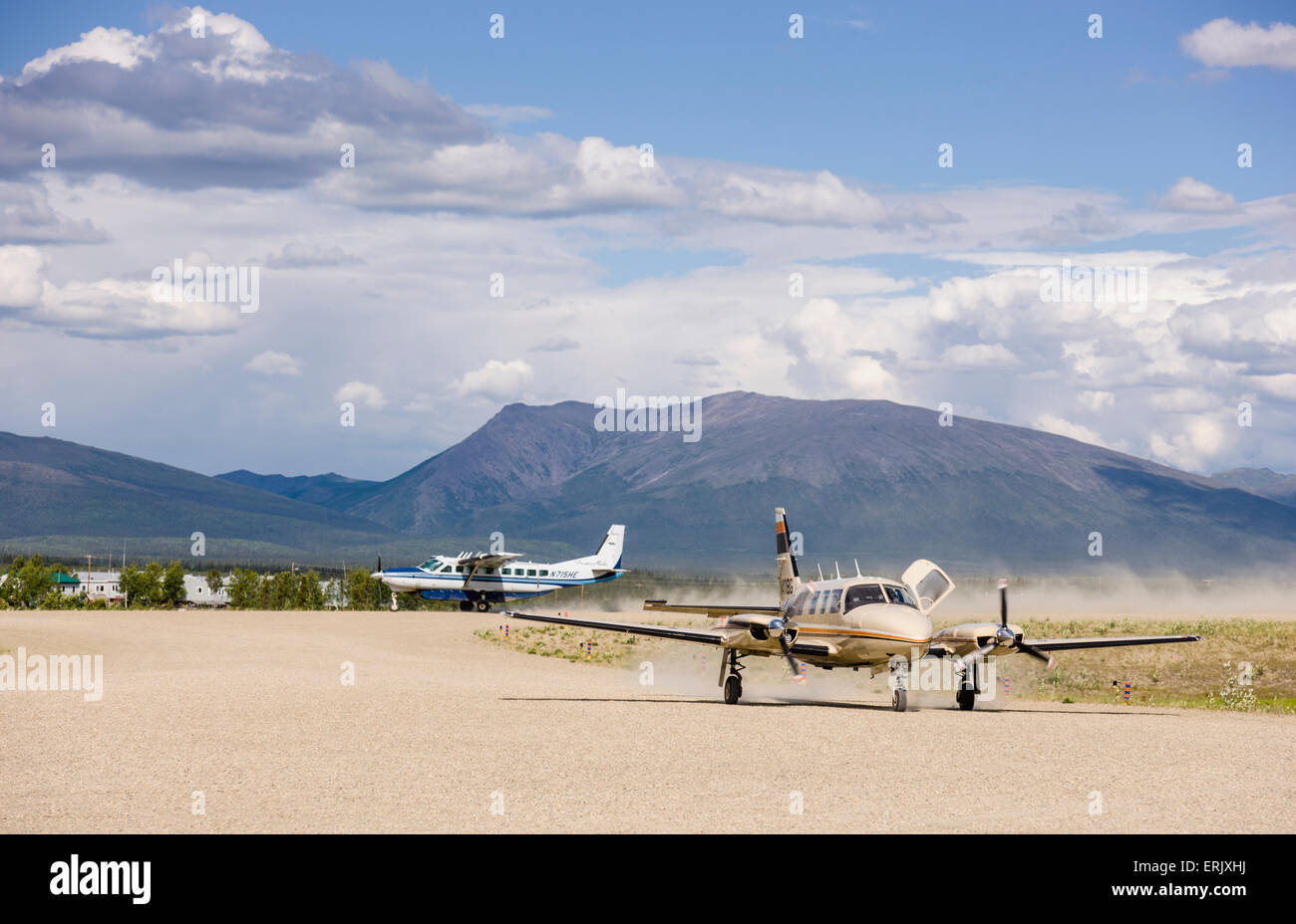 Airplanes on a dirt landing strip at the Shungnak Airport with Cosmos Mountain in the background, Arctic Alaska, summer Stock Photo