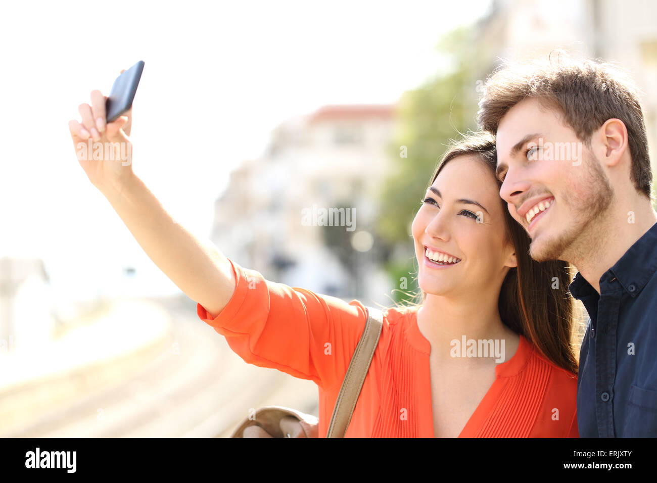 Traveler tourists couple photographing a selfie in a train station Stock Photo