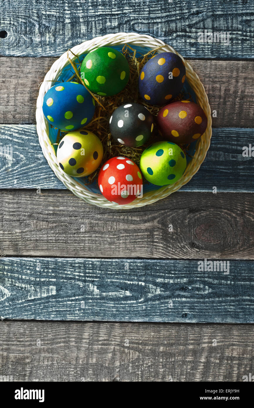 Easter eggs on a basket on wooden background Stock Photo - Alamy