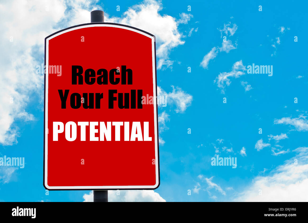 Reach Your Full Potential motivational quote written on red road sign isolated over clear blue sky background. Stock Photo