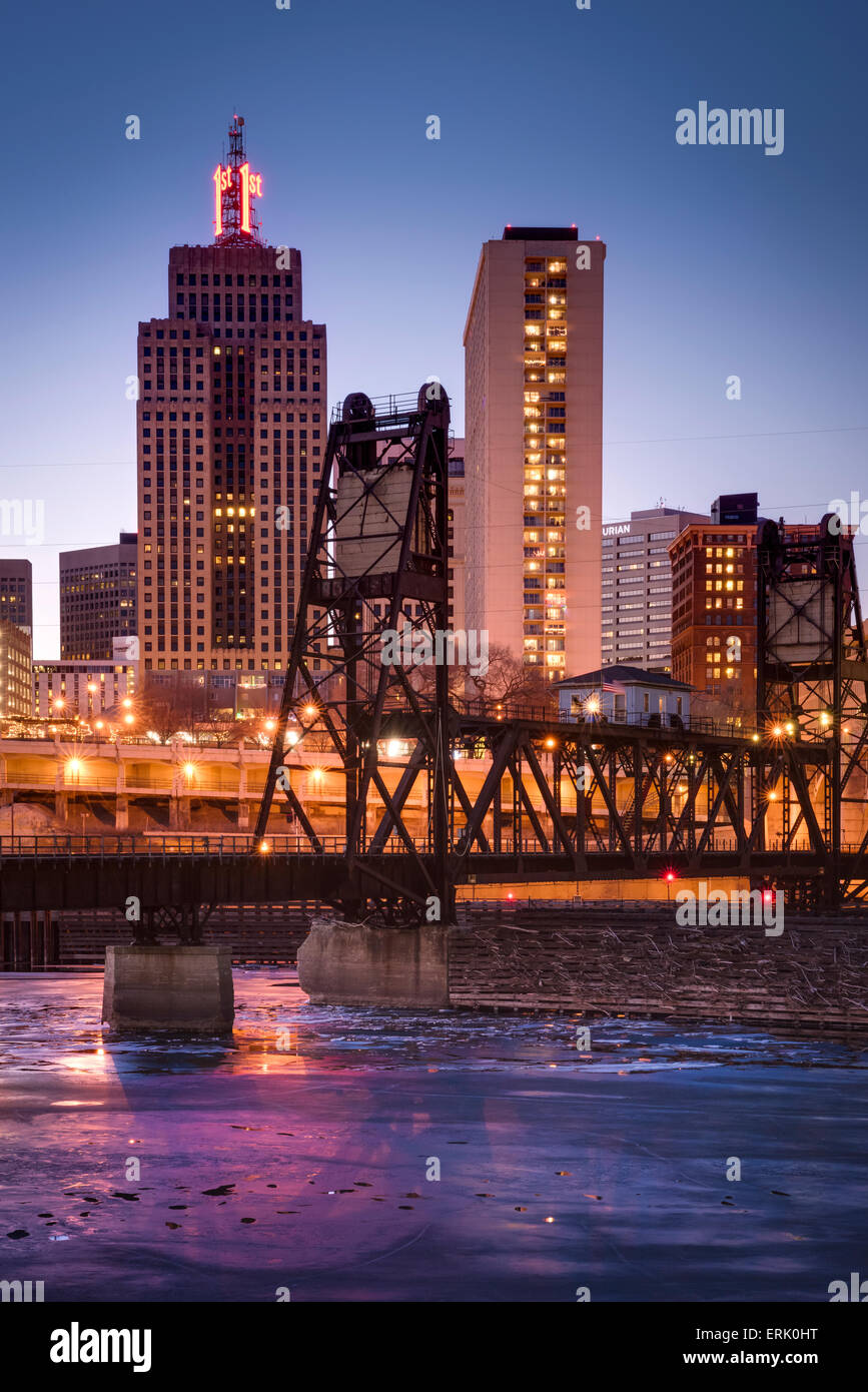 Ice covered Mississippi River and St. Paul skyline with railroad bridge at dusk. Stock Photo