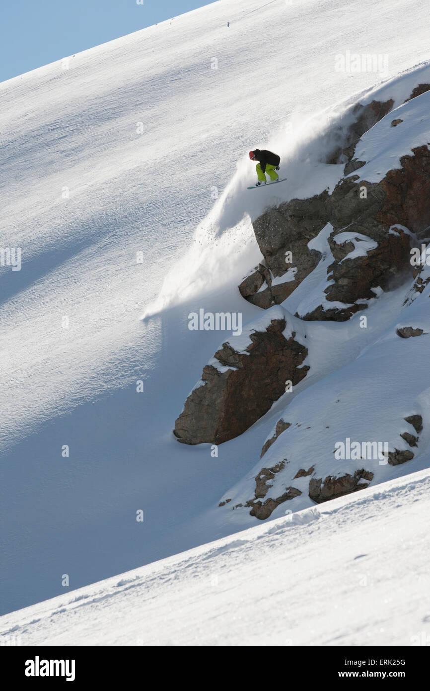Snowboarder on the extreme snowy slopes; Methven, New Zealand Stock