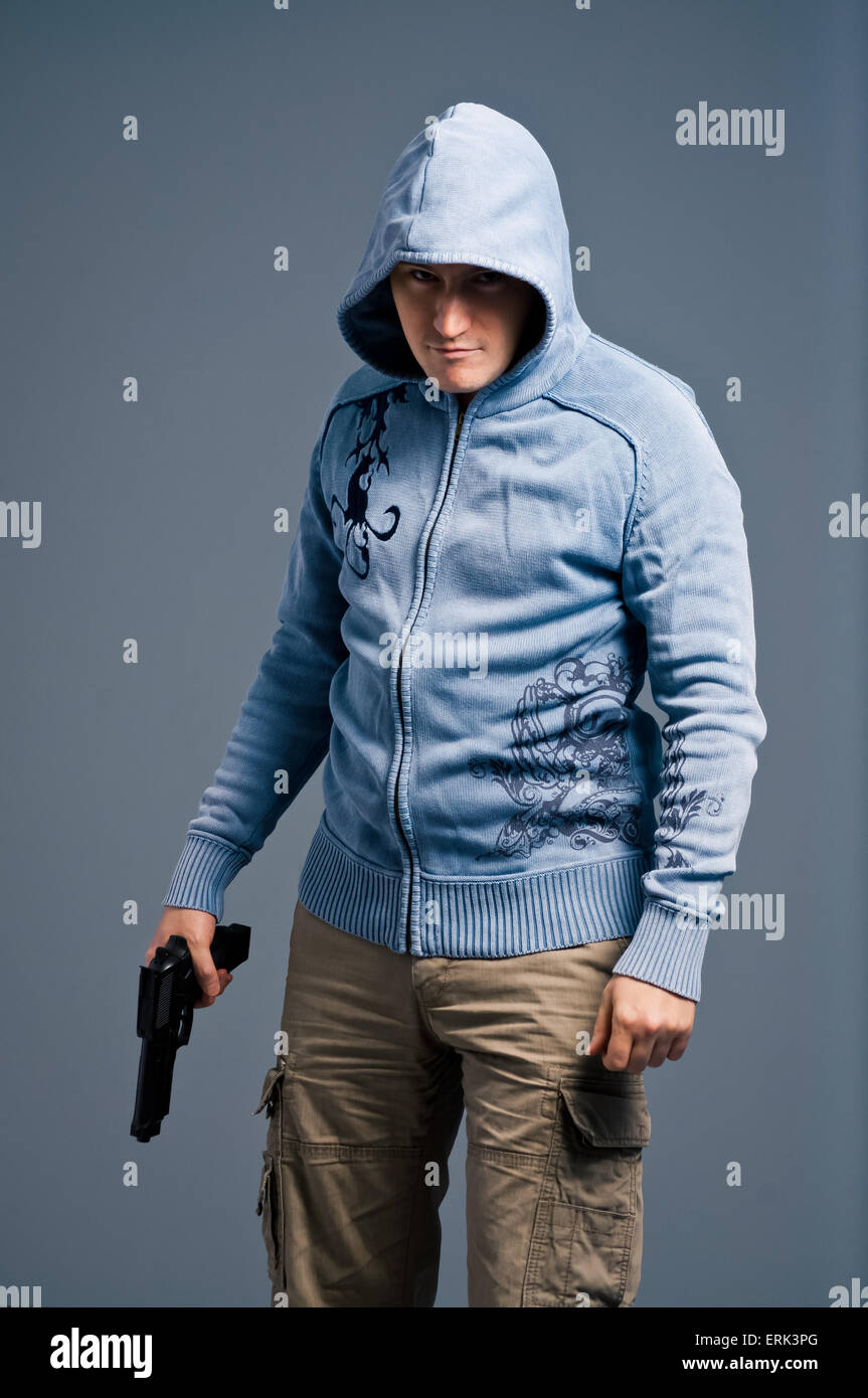 Aggressive young man with gun. Stock Photo